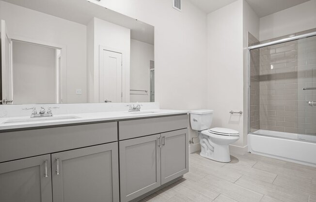 a bathroom with a toilet sink and shower