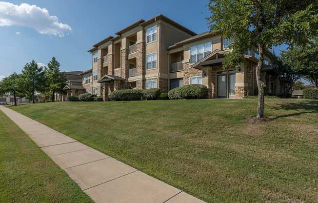 Buildings with a sidewalk at Woodbridge Villas Apartments, Texas, 75048