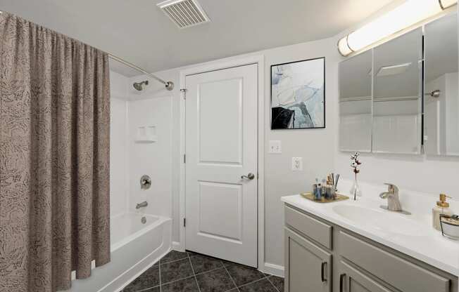 a bathroom with a shower and a sink and a mirror