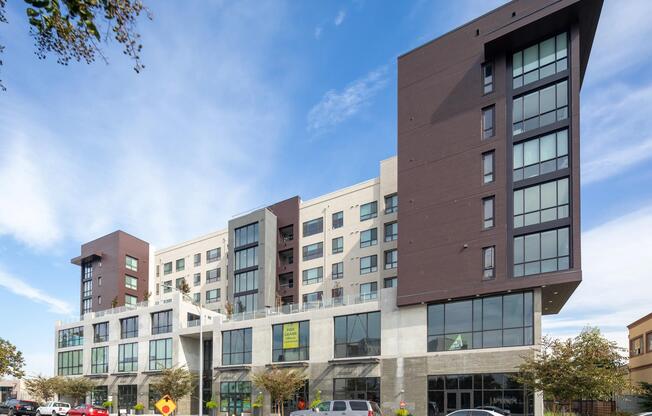 Street‑side view highlighting the building’s striking angles, expansive windows, and contemporary architectural design.