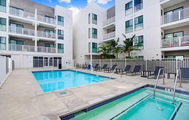 a swimming pool in front of an apartment building