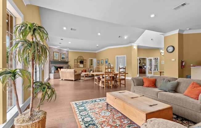 a living room with couches and tables and chairs