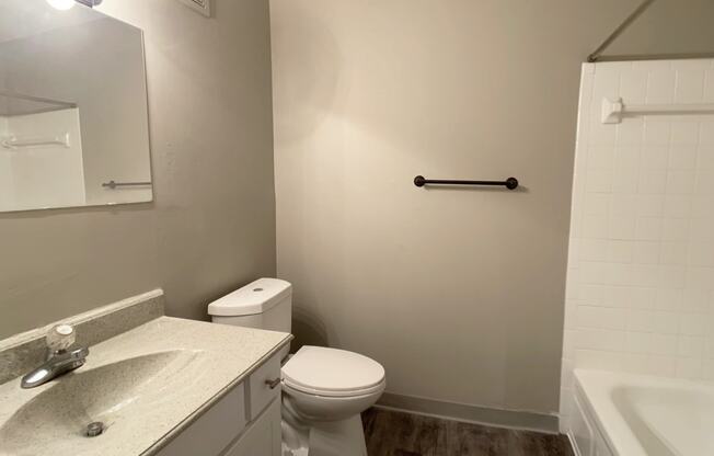 Image of a bathroom with vanity, medicine cabinet, toilet, and full-sized tub.