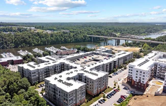 an aerial view of the campus with a bridge in the background