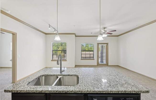 A kitchen with granite countertops and a sink.