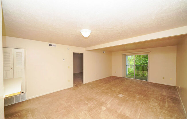 the living room and dining room  leading to sliding glass doors at Brentwood Park Apartments, La Vista, Nebraska