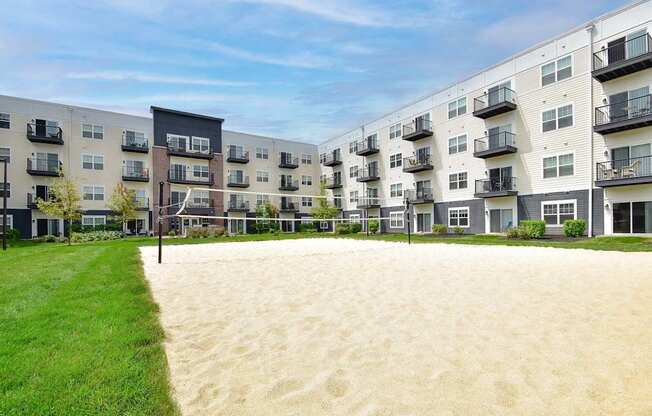 A sandy area in front of apartment buildings.