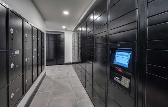 a row of black lockers with a screen in the middle