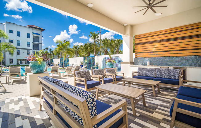 a patio with tables and chairs at the resort at longboat key club at Magnolia Square, Florida