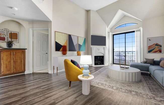 A living room with a yellow chair and a white coffee table.
