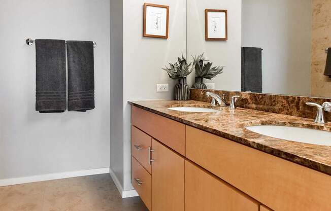 A bathroom with a brown counter top and a mirror.