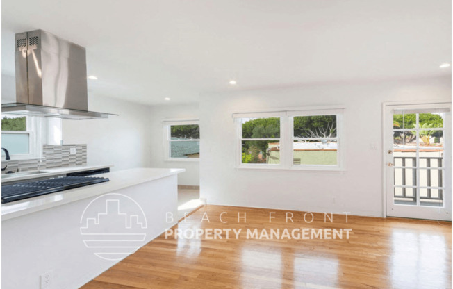 a kitchen with a white counter top and a window