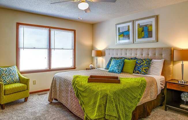 a bedroom with a large bed and a ceiling fan