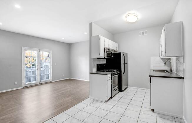 a kitchen with a stove and a refrigerator and a sink