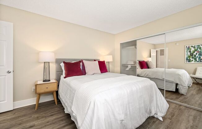 Two-Bedroom Apartments in Marina Del Rey Ca - Casa De Marina - Bedroom with White Bedding, Mirror Closet Sliding Doors, and Double Wooden Nightstands