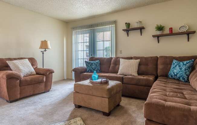 Somerpointe living room with plenty of couches and lounging space with carpet flooring