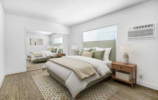 A bedroom with a large bed and a wooden nightstand.