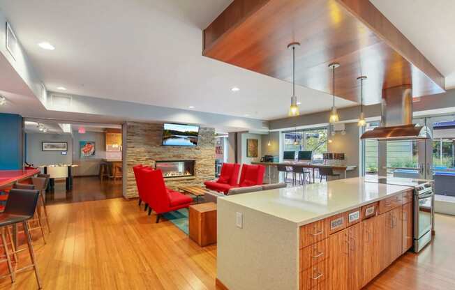 a large kitchen with a bar and a living room with a fireplace