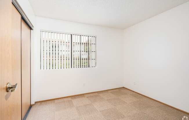 a bedroom with a door and a window