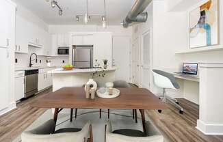 A modern kitchen with a dining table and chairs.