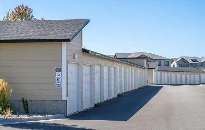 the side of a building with a row of garage doors