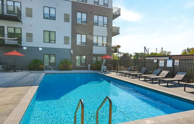 a swimming pool in front of an apartment building