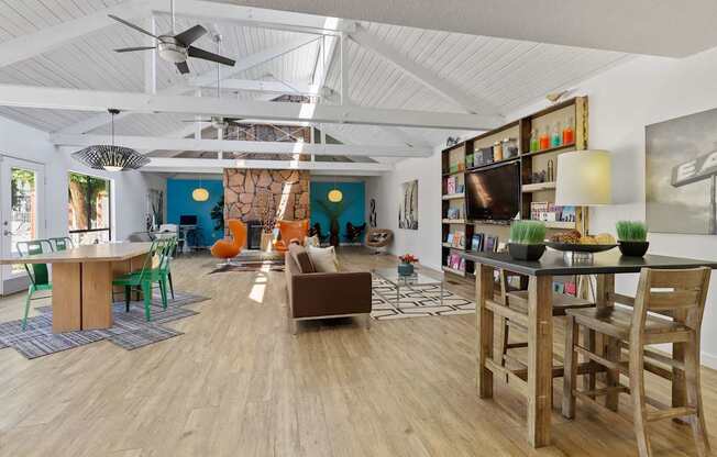 A living room with a wooden floor and a ceiling fan.