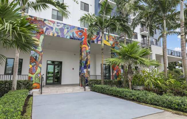 One of the entrances to our community with mural designs and palm trees at Bay Village 1 in Palmetto Bay, FL