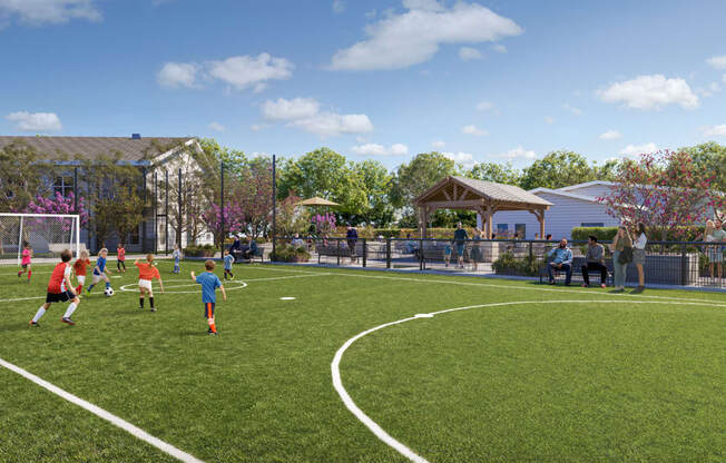 A group of people playing soccer on a field.