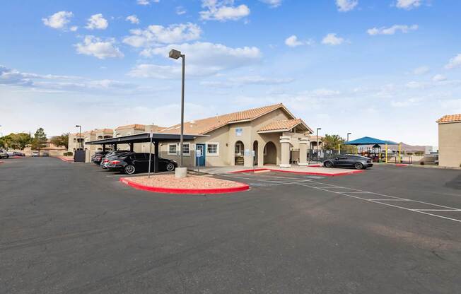 A parking lot with a building in the background.