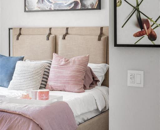 a bedroom with a bed and paintings on the wall