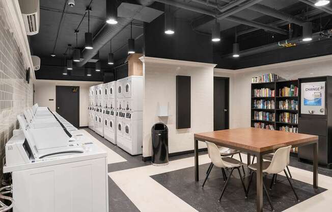 a dining room with a table and chairs and a washer and dryer room