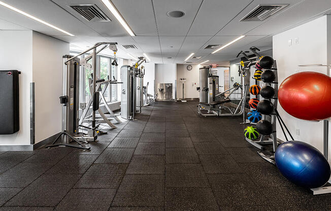 4545 Center Blvd Amenity Gym with weight machines, exercise balls, treadmills, and yoga  mats