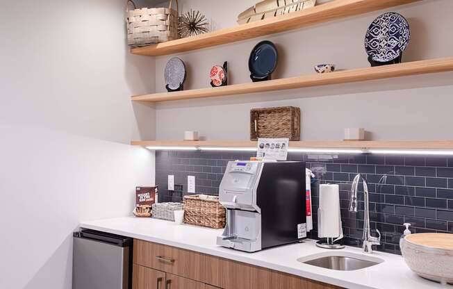 a kitchen with a sink and a coffee maker on the counter