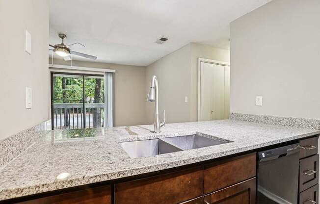 A kitchen with granite countertops and stainless steel appliances.