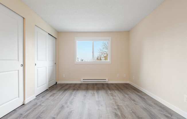 The Reserve at Bucklin Hill Apartments  bedroom with hardwood floors and beige walls