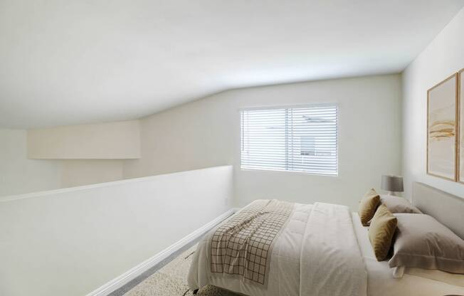 a white bedroom with a bed and a window