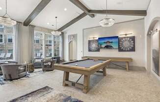 a game room with a pool table and shuffleboard