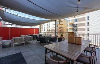 a large patio with a table and chairs under a canopy