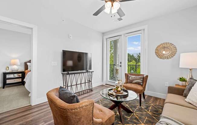 A living room with a brown leather chair and a glass coffee table.