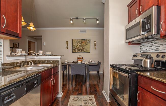 a large kitchen with stainless steel appliances and wooden cabinets