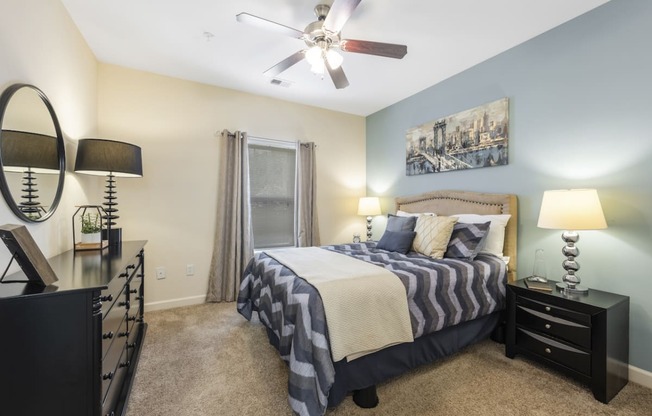 a bedroom with a bed and a ceiling fan