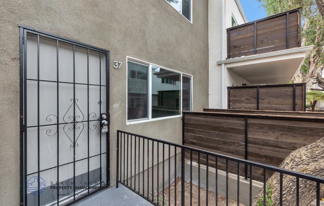 the entrance to a building with a gate and a balcony