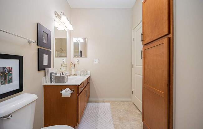 A bathroom with a white tub, sink, and toilet.