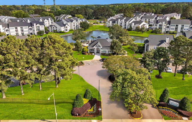 A residential area with houses and a lake.
