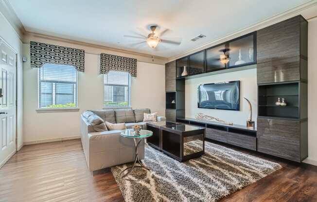 a living room with a couch and entertainment center