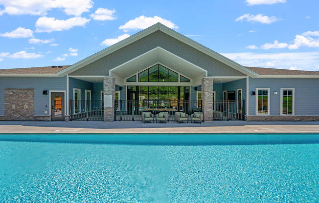 Sun deck with heated pool and lounge furniture at The Lodge Luxury Apartments in Rochester MN