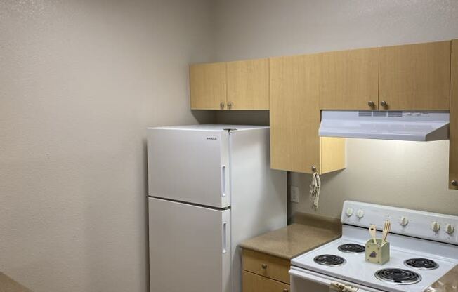 a kitchen with a stove refrigerator and a sink