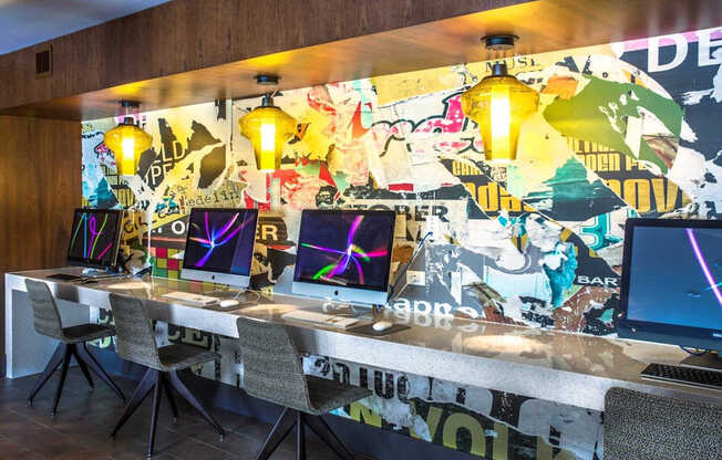 A room with a long table and chairs with a wall covered in posters.