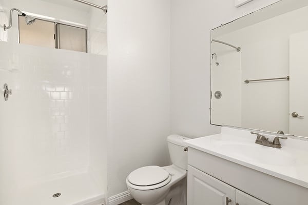 a white bathroom with a toilet and a sink at NOHO GALLERY Apartments, North Hollywood , CA